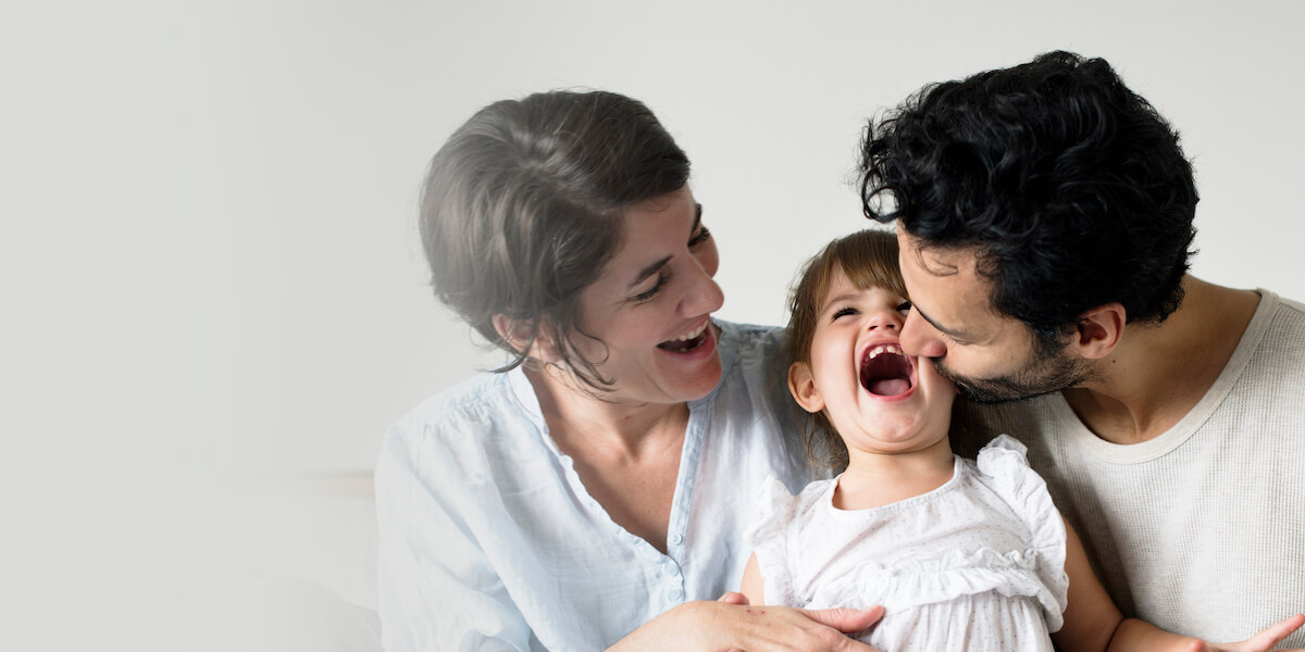 happy-parents-laughing-together-with-daughter (1)